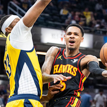 Apr 14, 2024; Indianapolis, Indiana, USA; Atlanta Hawks guard Dejounte Murray (5) shoots the ball while Indiana Pacers center Myles Turner (33) defends in the second half at Gainbridge Fieldhouse. Mandatory Credit: Trevor Ruszkowski-Imagn Images