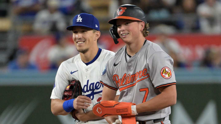 Aug 28, 2024; Los Angeles, California, USA;  Baltimore Orioles second baseman Jackson Holliday (7) and Los Angeles Dodgers shortstop Tommy Edman (25) at second base during the fifth inning at Dodger Stadium. 