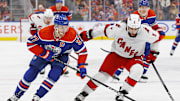 Dec 6, 2023; Edmonton, Alberta, CAN; Edmonton Oilers forward Connor McDavid (97) battles for position with Carolina Hurricanes defensemen Jalen Catfield (5) during the third period at Rogers Place. Mandatory Credit: Perry Nelson-Imagn Images
