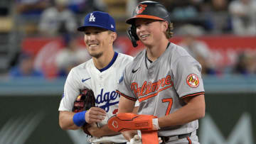 Aug 28, 2024; Los Angeles, California, USA;  Baltimore Orioles second baseman Jackson Holliday (7) and Los Angeles Dodgers shortstop Tommy Edman (25) at second base during the fifth inning at Dodger Stadium.