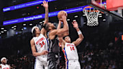 Jan 8, 2025; Brooklyn, New York, USA;  Brooklyn Nets forward Tosan Evbuomwan (12) looks to drive past Detroit Pistons forward Bobi Klintman (34) and guard Wendell Moore Jr. (14) in the fourth quarter at Barclays Center. Mandatory Credit: Wendell Cruz-Imagn Images