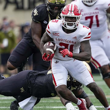 Sep 28, 2024; Winston-Salem, North Carolina, USA; Louisiana-Lafayette Ragin Cajuns running back Zylan Perry (21) runs for yards against the Wake Forest Demon Deacons during the first half at Allegacy Federal Credit Union Stadium. Mandatory Credit: Jim Dedmon-Imagn Images