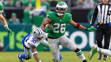 Dec 29, 2024; Philadelphia, Pennsylvania, USA; Philadelphia Eagles running back Saquon Barkley (26) runs with the ball past Dallas Cowboys safety Juanyeh Thomas (30) at Lincoln Financial Field. Mandatory Credit: Bill Streicher-Imagn Images