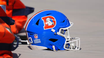 Oct 6, 2024; Denver, Colorado, USA; Detailed view of the throw back helmets worn by the Denver Broncos before the game against the Las Vegas Raiders at Empower Field at Mile High. Mandatory Credit: Ron Chenoy-Imagn Images