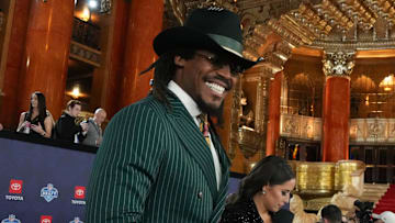 Cam Newton stands on the red carpet ahead of the 2024 NFL Draft in Detroit.