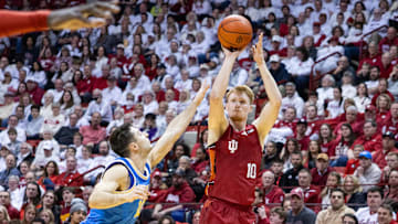 Feb 14, 2025; Bloomington, Indiana, USA; Indiana Hoosiers forward Luke Goode (10) shoots the ball while UCLA Bruins guard Lazar Stefanovic (10) defends in the first half at Simon Skjodt Assembly Hall. Mandatory Credit: Trevor Ruszkowski-Imagn Images
