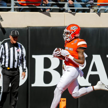 Oct 14, 2023; Stillwater, Oklahoma, USA; Oklahoma State's Ollie Gordon II (0) scores a touchdown in the first quarter against the Kansas Jayhawks at Boone Pickens Stadium. Mandatory Credit: Nathan J. Fish-USA TODAY Sports