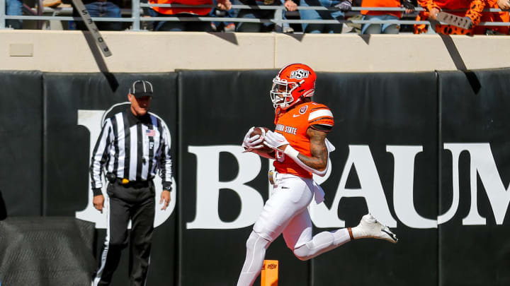 Oct 14, 2023; Stillwater, Oklahoma, USA; Oklahoma State's Ollie Gordon II (0) scores a touchdown in the first quarter against the Kansas Jayhawks at Boone Pickens Stadium. Mandatory Credit: Nathan J. Fish-USA TODAY Sports