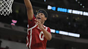 Mar 21, 2025; Raleigh, NC, USA;  Oklahoma Sooners guard Jeremiah Fears (0) puts up shot against Connecticut Huskies forward Liam McNeeley (30) during the second half at Lenovo Center. Mandatory Credit: Zachary Taft-Imagn Images