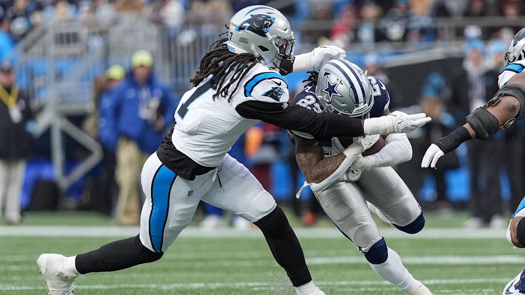 Dec 15, 2024; Charlotte, North Carolina, USA; Dallas Cowboys wide receiver Jalen Brooks (83) is tackled by Carolina Panthers linebacker Jadeveon Clowney (7) during the second half at Bank of America Stadium. Mandatory Credit: Jim Dedmon-Imagn Images
