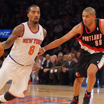Feb 5, 2014; New York, NY, USA; New York Knicks shooting guard J.R. Smith (8) drives on Portland Trailblazers small forward Nicolas Batum (88) during the third quarter of a game at Madison Square Garden. The Trailblazers defeated the Knicks 94-90. Mandatory Credit: Brad Penner-Imagn Images