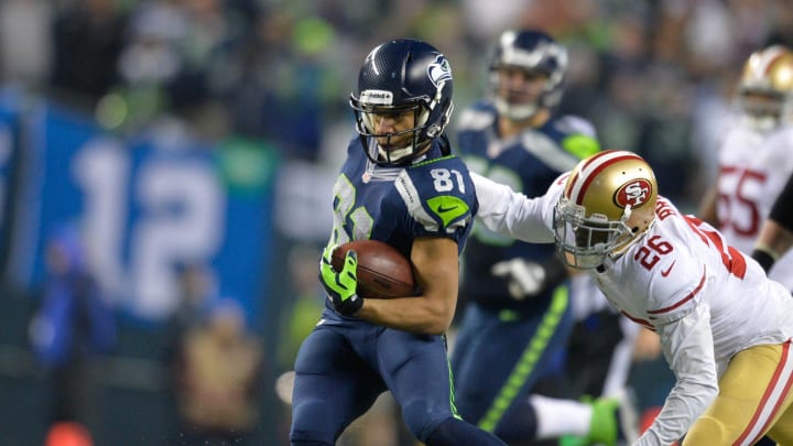 Jan 19, 2014; Seattle, WA, USA; Seattle Seahawks wide receiver Golden Tate (81) breaks a tackle by San Francisco 49ers cornerback Tramaine Brock (26) during the 2013 NFC Championship football game at CenturyLink Field. Seattle defeated San Francisco 23-17. Mandatory Credit: Steven Bisig-USA TODAY Sports