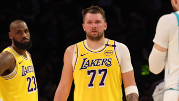 Feb 19, 2025; Los Angeles, California, USA; Los Angeles Lakers forward LeBron James (23) and guard Luka Doncic (77) during the second quarter against the Charlotte Hornets at Crypto.com Arena. Mandatory Credit: Jason Parkhurst-Imagn Images