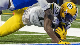 Green Bay Packers receiver Dontayvion Wicks dives for the end zone for a touchdown against Lions cornerback Terrion Arnold.