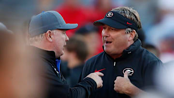 Georgia coach Kirby Smart speaks with Kentucky coach Mark Stoops before the start of a NCAA college football game against Kentucky in Athens, Ga., on Saturday, Oct. 7, 2023.