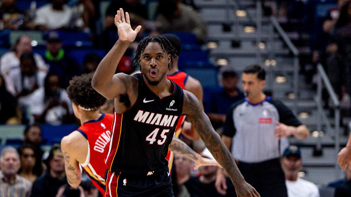 Apr 11, 2025; New Orleans, Louisiana, USA; Miami Heat guard Davion Mitchell (45) reacts taking a basket against New Orleans Pelicans guard Lester Quinones (22) during the second half at Smoothie King Center. Mandatory Credit: Stephen Lew-Imagn Images