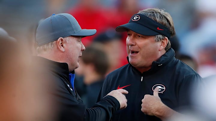 Georgia coach Kirby Smart speaks with Kentucky coach Mark Stoops before the start of a NCAA college football game against Kentucky in Athens, Ga., on Saturday, Oct. 7, 2023.