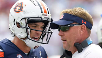 Auburn Tigers head coach Hugh Freeze talks with quarterback Payton Thorne (1) on the sidelines