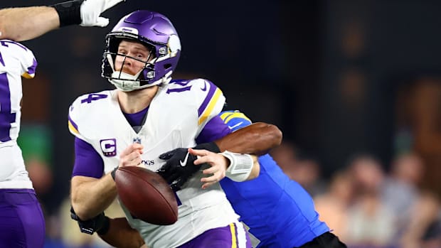Minnesota Vikings quarterback Sam Darnold is sacked by Los Angeles Rams cornerback Ahkello Witherspoon.