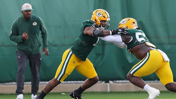 Green Bay Packers defensive ends Micah Parsons (1) and Brenton Cox Jr. (57) run through a drill during practice on Wednesday,