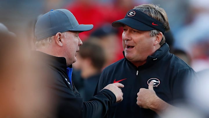 Georgia coach Kirby Smart speaks with Kentucky coach Mark Stoops before the start of a NCAA college football game against Kentucky in Athens, Ga., on Saturday, Oct. 7, 2023.