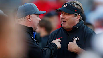 Georgia coach Kirby Smart speaks with Kentucky coach Mark Stoops before the start of a NCAA college football game against Kentucky in Athens, Ga., on Saturday, Oct. 7, 2023.