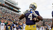 Notre Dame running back Jeremiyah Love makes a heart sign after scoring a touchdown against Syracuse 