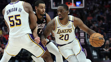 Former Los Angeles Lakers guard Shake Milton (20) dribbles the ball around his teammate, Lakers’ center Trey Jemison III (55), past Portland Trail Blazers forward Kris Murray (24) in the second half at Moda Center.