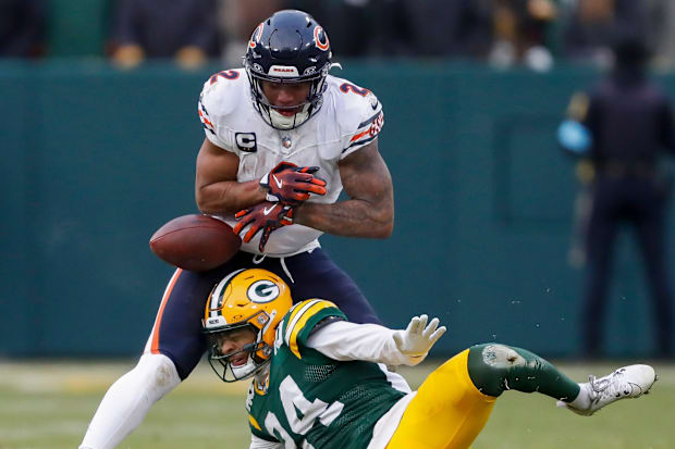 Green Bay Packers cornerback Carrington Valentine forces a fumble by Chicago Bears wide receiver DJ Moore