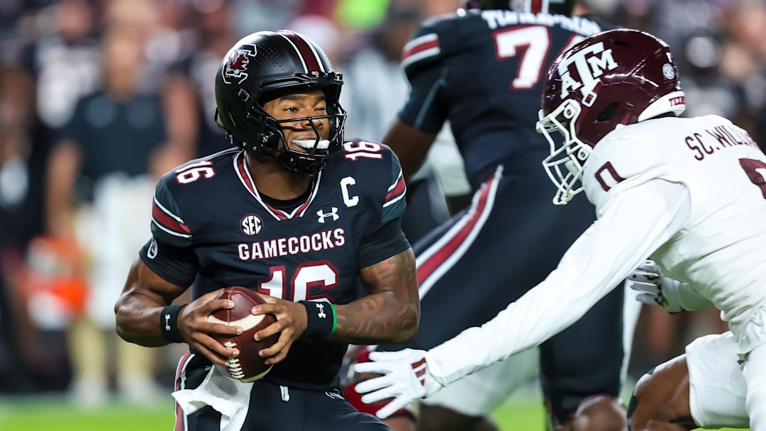 Nov 2, 2024; Columbia, South Carolina, USA; South Carolina Gamecocks quarterback LaNorris Sellers (16) eludes a sack by Texas A&M Aggies linebacker Scooby Williams (0) in the first quarter at Williams-Brice Stadium. Mandatory Credit: Jeff Blake-Imagn Images