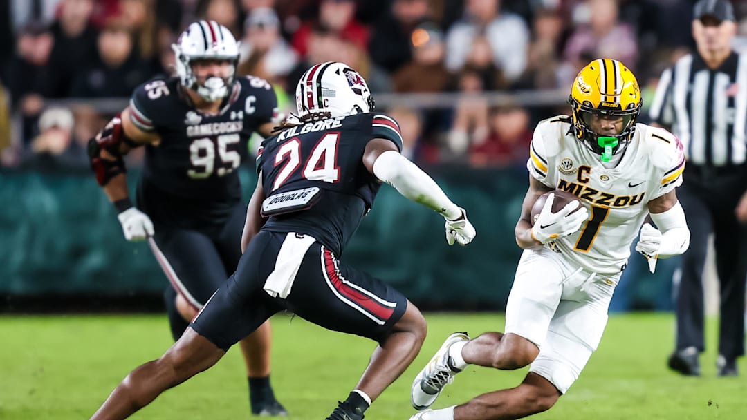 Nov 16, 2024; Columbia, South Carolina, USA; Missouri Tigers wide receiver Theo Wease Jr. (1) runs after a reception against South Carolina Gamecocks defensive back Jalon Kilgore (24) in the second half at Williams-Brice Stadium. Mandatory Credit: Jeff Blake-Imagn Images