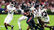 Nov 2, 2024; Columbia, South Carolina, USA; South Carolina Gamecocks running back Raheim Sanders (5) is brought down by Texas A&M Aggies defensive back Marcus Ratcliffe (3) in the second quarter at Williams-Brice Stadium. Mandatory Credit: Jeff Blake-Imagn Images