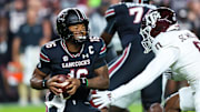 Nov 2, 2024; Columbia, South Carolina, USA; South Carolina Gamecocks quarterback LaNorris Sellers (16) eludes a sack by Texas A&M Aggies linebacker Scooby Williams (0) in the first quarter at Williams-Brice Stadium. Mandatory Credit: Jeff Blake-Imagn Images