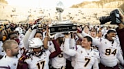 Dec 27, 2014; El Paso, TX, USA; Arizona State players hold up the Hyundai Sun Bowl Trophy after winning the 2014 Sun Bowl at Sun Bowl Stadium. The Sun Devils defeated the Blue Devils 36-31. Mandatory Credit: Ivan Pierre Aguirre-Imagn Images