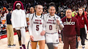 Jan 24, 2025; Columbia, South Carolina, USA; South Carolina Gamecocks guard Tessa Johnson (5), guard Te-Hina Paopao (0), and head coach Dawn Staley celebrate their win over the LSU Lady Tigers at Colonial Life Arena. Mandatory Credit: Jeff Blake-Imagn Images