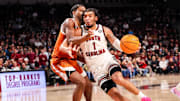Feb 22, 2025; Columbia, South Carolina, USA; South Carolina Gamecocks guard Jacobi Wright (1) drives past Texas Longhorns guard Tramon Mark (12) in the first half at Colonial Life Arena. Mandatory Credit: Jeff Blake-Imagn Images