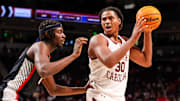 Mar 4, 2025; Columbia, South Carolina, USA; South Carolina Gamecocks forward Collin Murray-Boyles (30) attempts to get around Georgia Bulldogs forward Dylan James (13) in the first half at Colonial Life Arena. Mandatory Credit: Jeff Blake-Imagn Images