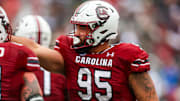 Nov 11, 2023; Columbia, South Carolina, USA; South Carolina Gamecocks defensive tackle Alex Huntley (95) celebrates after making a touchdown reception on offense against the Vanderbilt Commodores in the first quarter at Williams-Brice Stadium. Mandatory Credit: Jeff Blake-Imagn Images