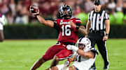 Sep 6, 2025; Columbia, South Carolina, USA; South Carolina Gamecocks quarterback LaNorris Sellers (16) passes as he is brought down by South Carolina State Bulldogs defensive end Mike Lunz (11) in the second quarter at Williams-Brice Stadium. Mandatory Credit: Jeff Blake-Imagn Images