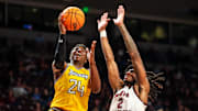 Nov 12, 2024; Columbia, South Carolina, USA; Towson Tigers guard Nendah Tarke (24) drives around South Carolina Gamecocks guard Zachary Davis (2) in the second half at Colonial Life Arena. Mandatory Credit: Jeff Blake-Imagn Images