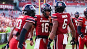 Aug 31, 2024; Columbia, South Carolina, USA; South Carolina Gamecocks quarterback Dante Reno (10), quarterback LaNorris Sellers (16) and tight end Joshua Simon (6) celebrate after a touchdown.