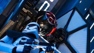 A First Order Stormtrooper stands guard in a Star Destroyer hangar bay beneath a docked TIE fighter in Star Wars: Rise of the Resistance, the groundbreaking new attraction opening Dec. 5, 2019, inside Star Wars: Galaxy’s Edge at Disney’s Hollywood Studios in Florida and Jan. 17, 2020, at Disneyland Park in California. Guests enter the hangar bay after their ship is caught in the Star Destroyer’s tractor beam. (Matt Stroshane, photographer)
