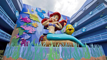 Surrounded by Flounder and friends, a larger-than-life Ariel overlooks "The Little Mermaid"