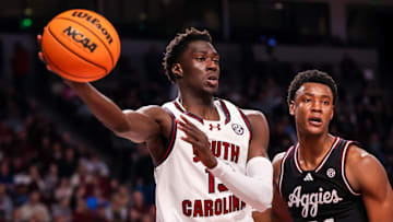 Feb 1, 2025; Columbia, South Carolina, USA; South Carolina Gamecocks guard Morris Ugusuk (15) passes around Texas A&M Aggies forward Pharrel Payne (21) in the first half at Colonial Life Arena. Mandatory Credit: Jeff Blake-Imagn Images
