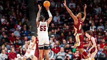 Dec 22, 2023; Columbia, South Carolina, USA; South Carolina Gamecocks guard Ta'Lon Cooper (55) shoots the ball as Elon Phoenix guard Nick Dorn (0) defends in the second half at Colonial Life Arena. Mandatory Credit: Jeff Blake-Imagn Images