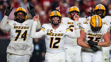 Nov 16, 2024; Columbia, South Carolina, USA; Missouri Tigers quarterback Brady Cook (12) and teammates celebrate after a touchdown against the South Carolina Gamecocks in the second half at Williams-Brice Stadium. Mandatory Credit: Jeff Blake-Imagn Images