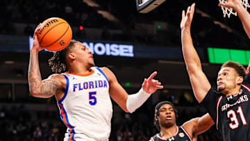 Jan 22, 2025; Columbia, South Carolina, USA; Florida Gators guard Will Richard (5) passes around South Carolina Gamecocks forward Benjamin Bosmans-Verdonk (31) in the second half at Colonial Life Arena. Mandatory Credit: Jeff Blake-Imagn Images