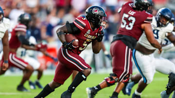 South Carolina football running back Rocket Sanders (5) running behind center Vershon Lee (53)