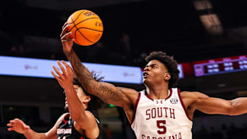 Mar 4, 2025; Columbia, South Carolina, USA; South Carolina Gamecocks forward Nick Pringle (5) grabs a rebound from Georgia Bulldogs forward Asa Newell (14) in the second half at Colonial Life Arena. Mandatory Credit: Jeff Blake-Imagn Images