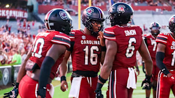 Aug 31, 2024; Columbia, South Carolina, USA; South Carolina Gamecocks quarterback Dante Reno (10), quarterback LaNorris Sellers (16) and tight end Joshua Simon (6) celebrate after a touchdown against the Old Dominion Monarchs in the second half at Williams-Brice Stadium. Mandatory Credit: Jeff Blake-Imagn Images